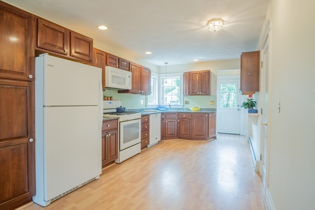 47 Pilgrim Road Marblehead, MA 01945 - Photo 7 of 42 a kitchen with stainless steel appliances granite countertop a refrigerator a sink a stove a microwave a counter space and cabinets