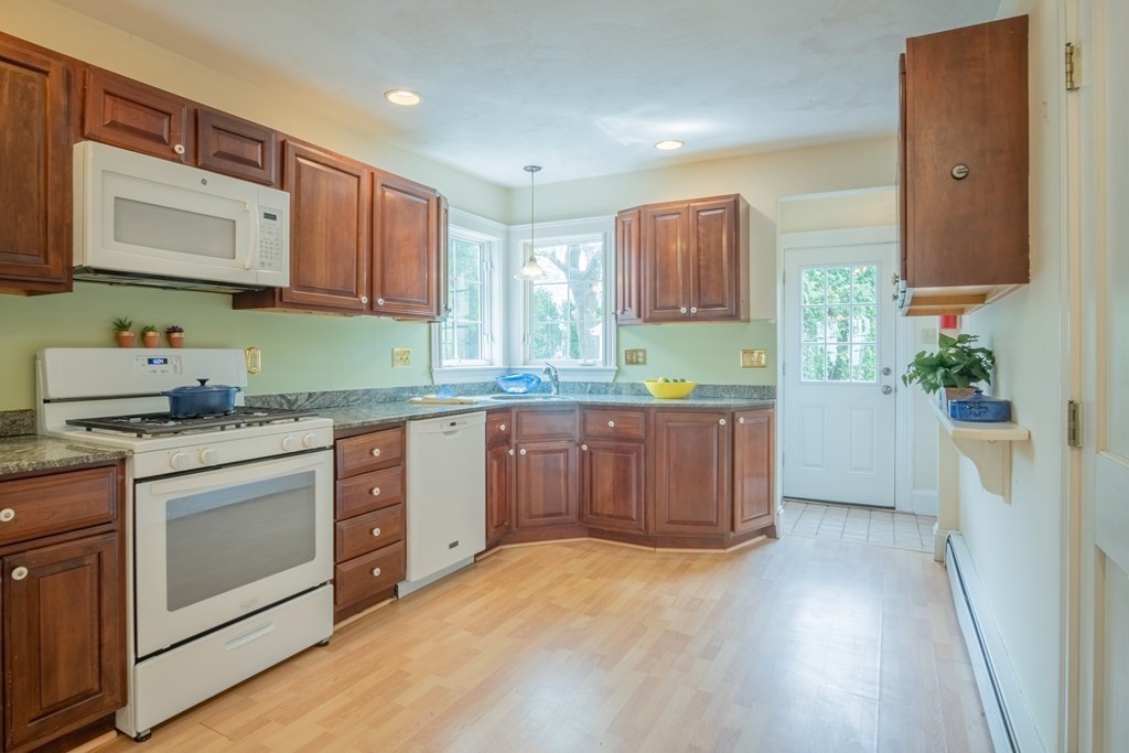 47 Pilgrim Road Marblehead, MA 01945 - Photo 9 of 42 a kitchen with stainless steel appliances granite countertop a stove a sink and a microwave