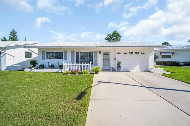 a view of house with yard outdoor seating and green space