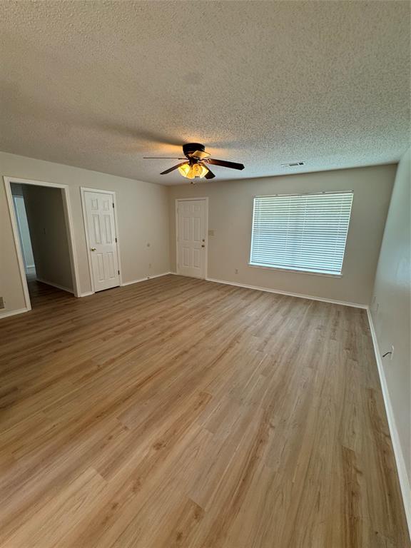 1109 North Riggins Street Anna, TX 75409 - Photo 2 of 11 an empty room with wooden floor and windows