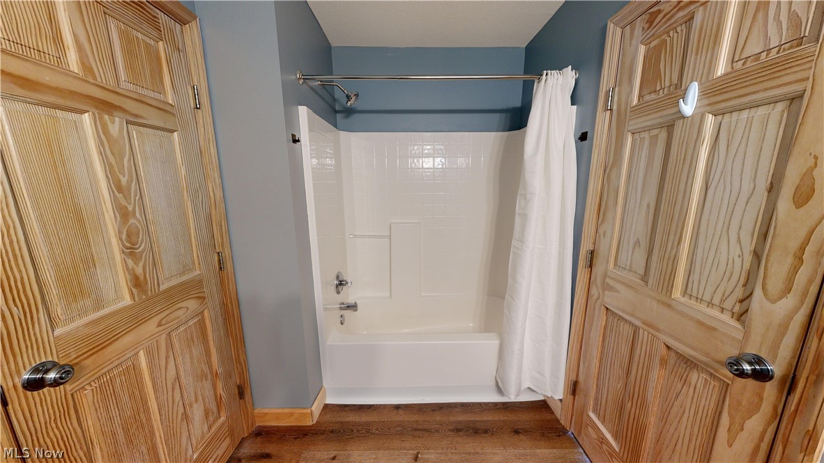 15548 Trask Road Thompson, OH 44086 - Photo 24 of 31 Bathroom with shower / bath combo and wood-type flooring