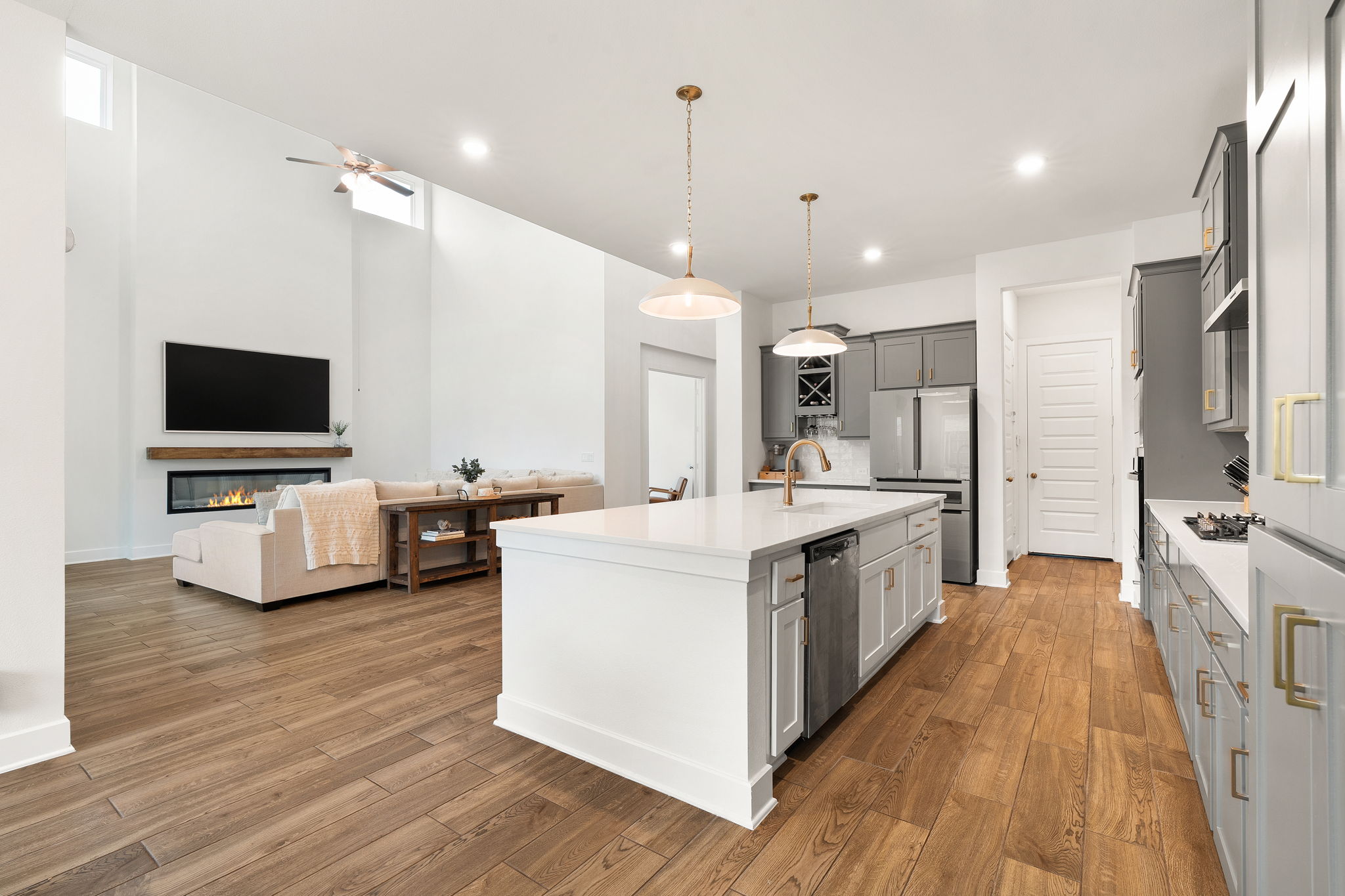 515 Watershield Cove Georgetown, TX 78633 - Photo 14 of 40 An open concept design seamlessly connects the kitchen and living room, bathed in natural light.