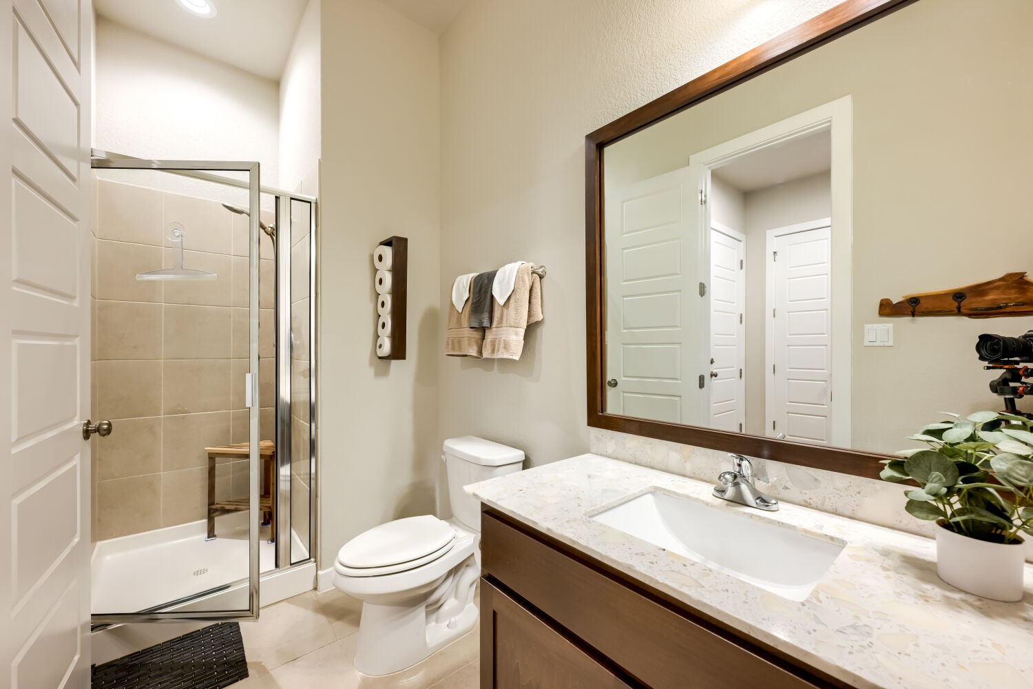 621 Rancho Sienna Loop Georgetown, TX 78628 - Photo 19 of 28 A well-appointed bathroom features a spacious shower with tile surround and a vanity with a large mirror.