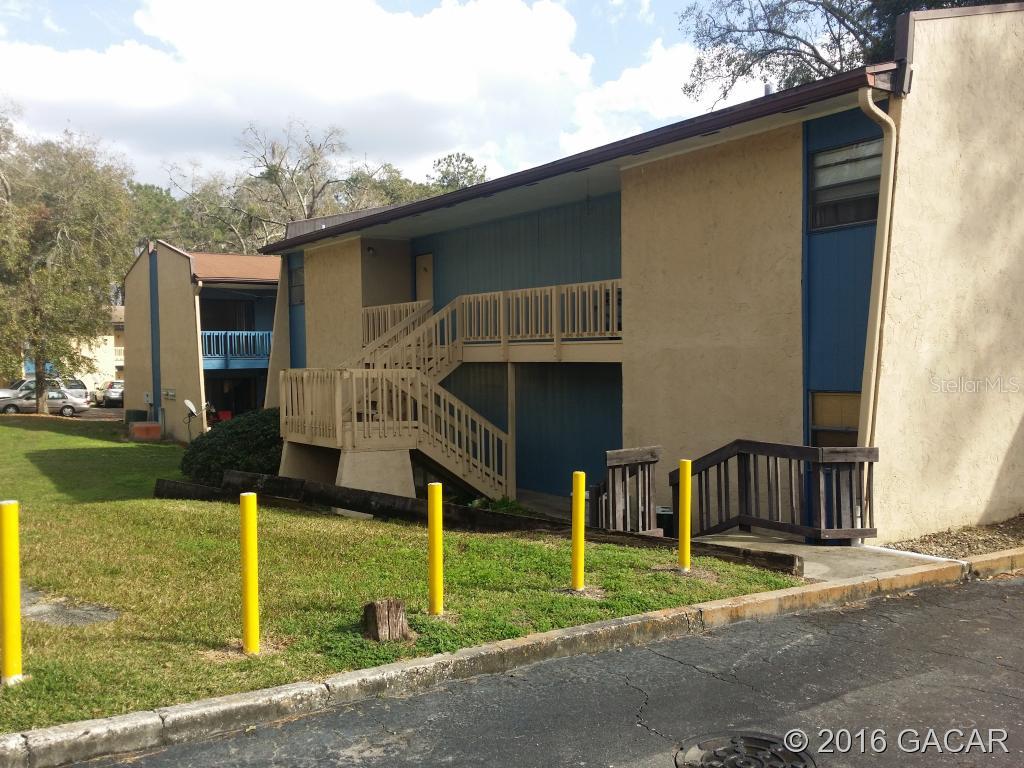2811 Southwest Archer Road, Unit W200 Gainesville, FL 32608 - Photo 1 of 1 a view of house with swimming pool and a yard