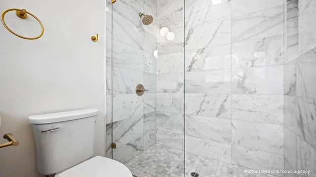a white toilet sitting next to a bathroom sink