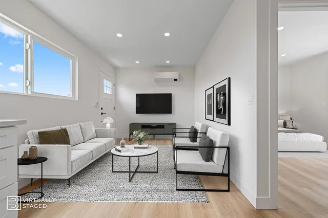 a kitchen with stainless steel appliances a sink cabinets and wooden floor