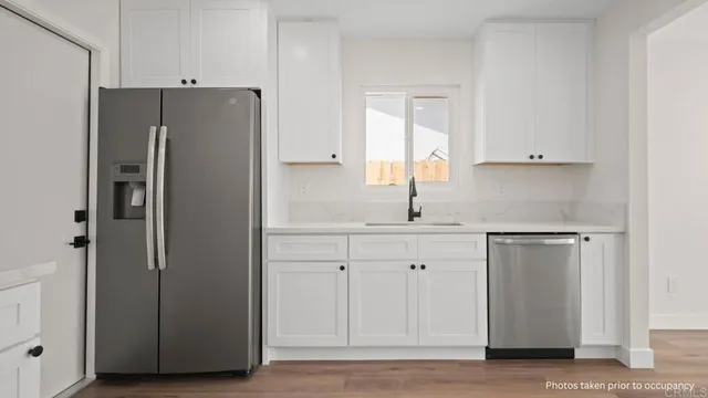 a kitchen with cabinets and stainless steel appliances