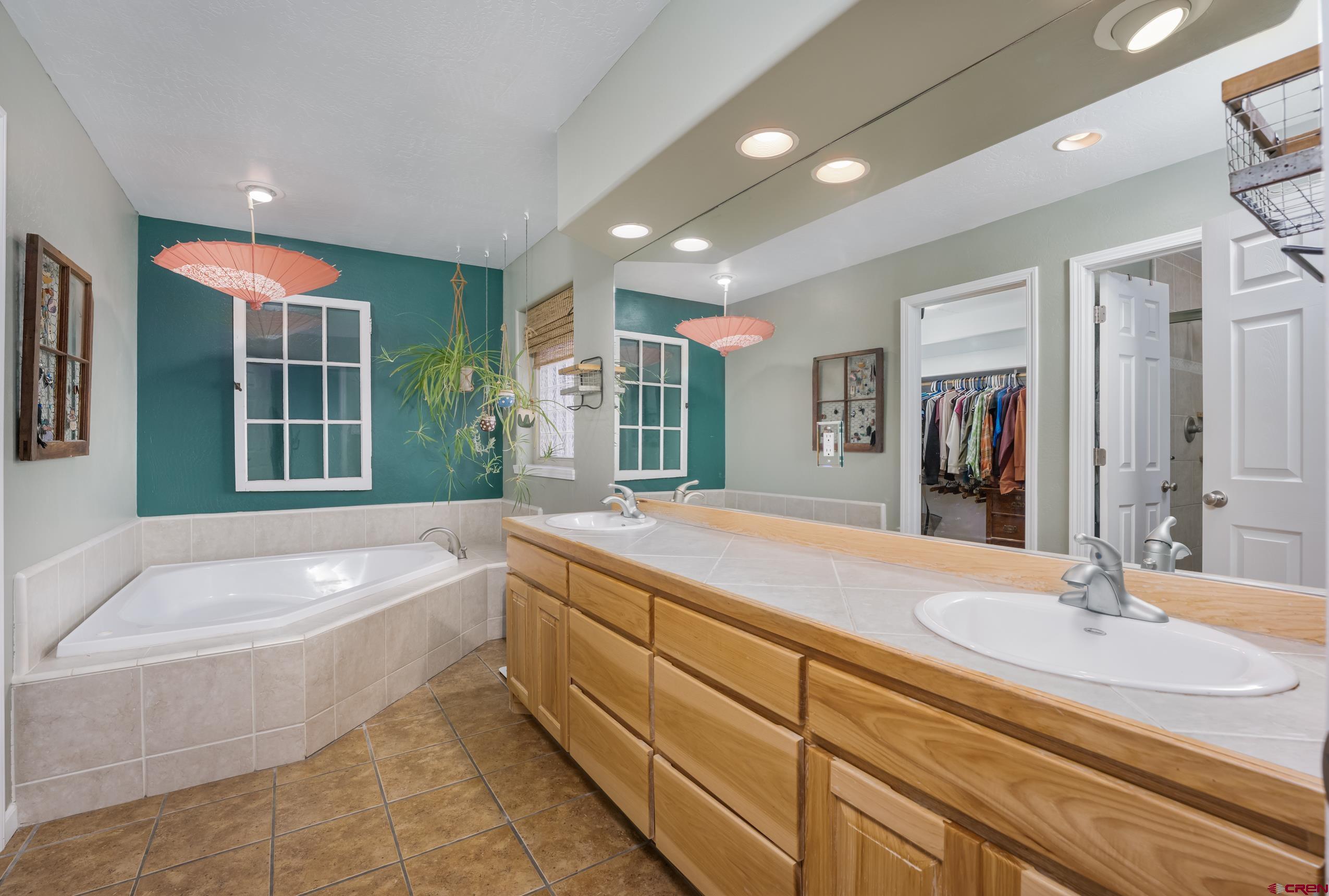 517 Dove Ranch Road Bayfield, CO 81122 - Photo 11 of 29 a spacious bathroom with a granite countertop tub sink and mirror