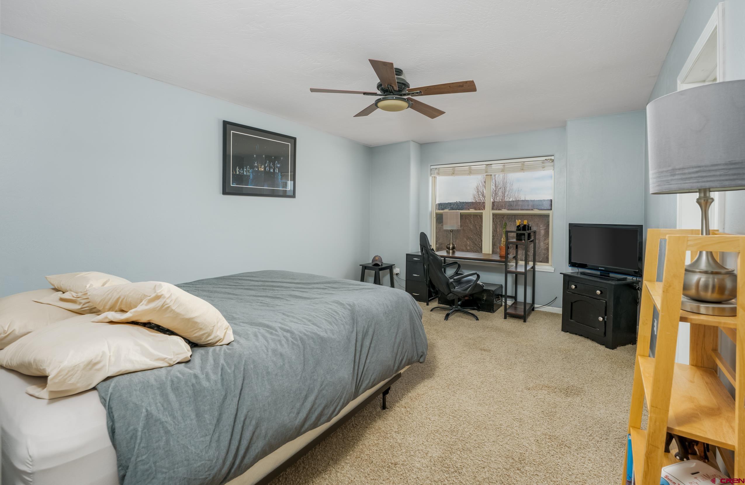 517 Dove Ranch Road Bayfield, CO 81122 - Photo 20 of 29 a bedroom with a bed furniture and a flat screen tv