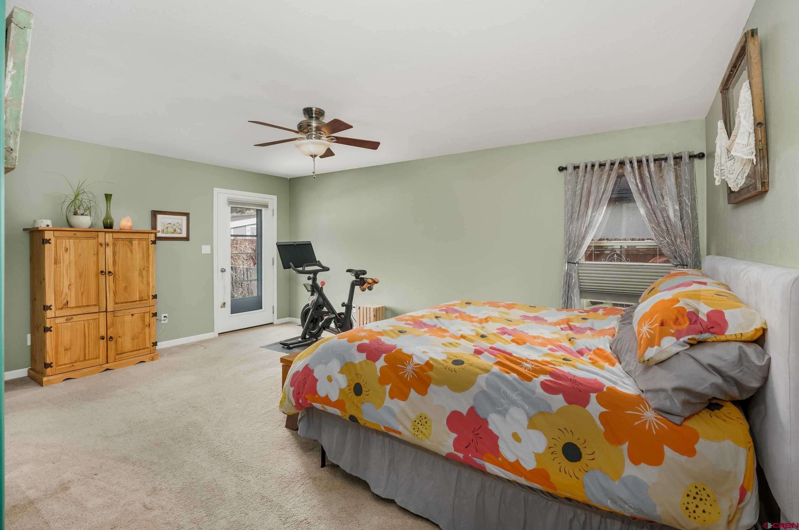 517 Dove Ranch Road Bayfield, CO 81122 - Photo 9 of 29 a bedroom with a bed and a chandelier