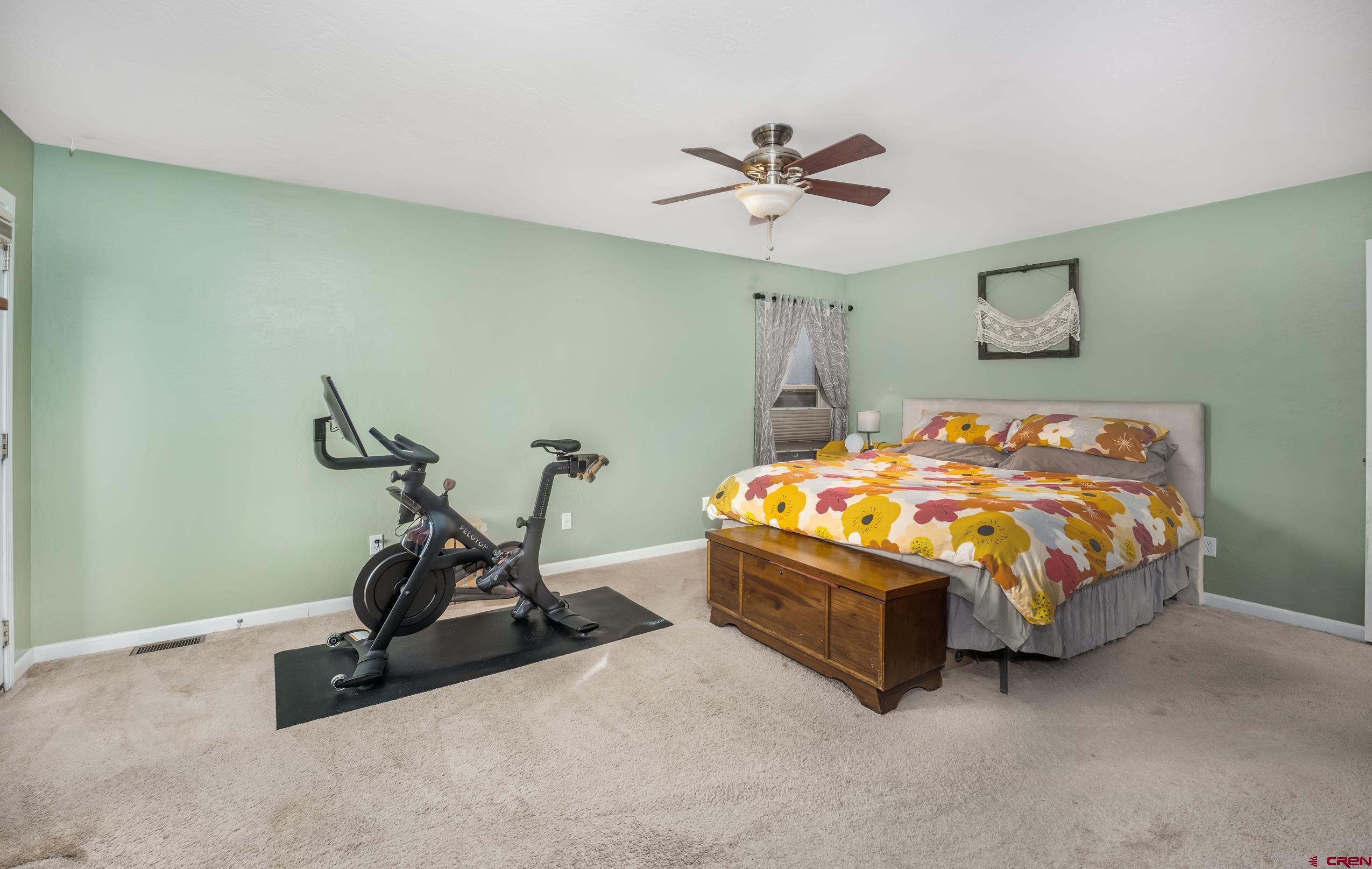 517 Dove Ranch Road Bayfield, CO 81122 - Photo 10 of 29 a bedroom with a bed and a ceiling fan