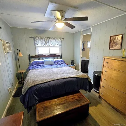 a bedroom with a bed and a large mirror