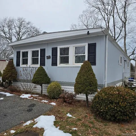 a view of a house with a yard and sitting area