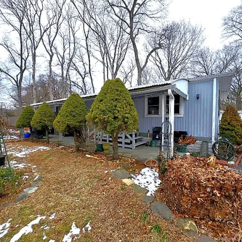 a view of a house with a yard covered in snow