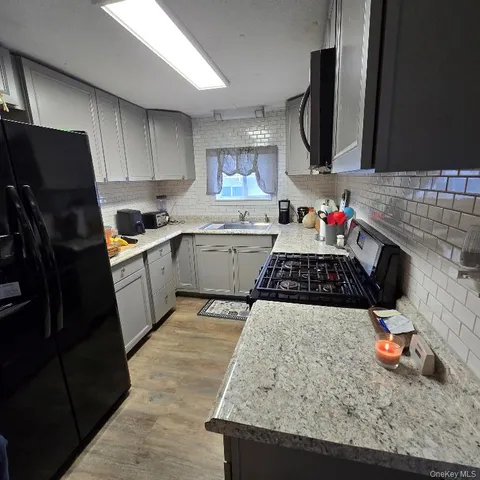 a kitchen with a sink stove and microwave