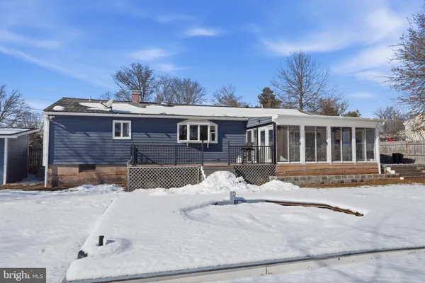 a view of a house with snow on the road