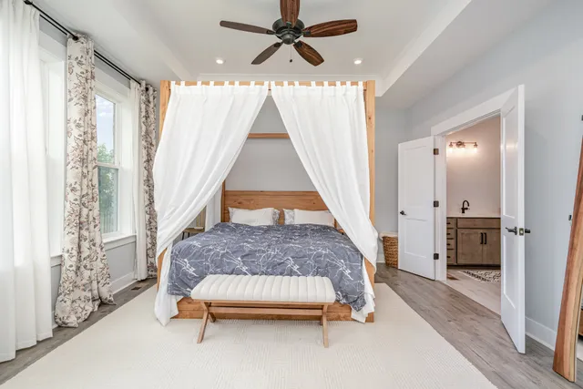 a bedroom with a bed and a chandelier