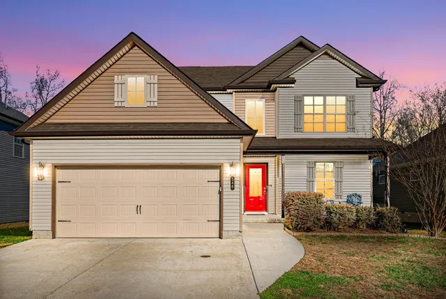 a front view of a house with a yard and garage