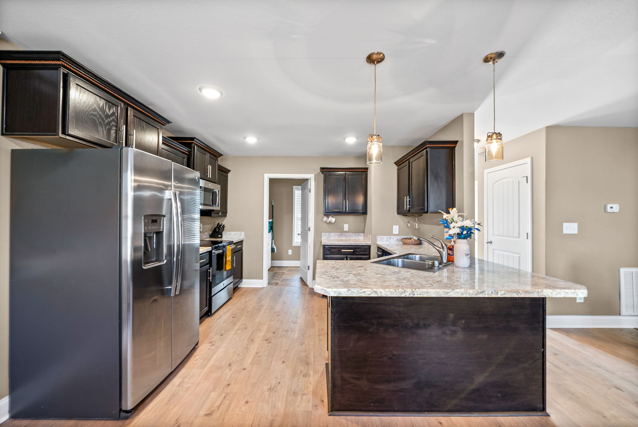 548 Medallion Circle Clarksville, TN 37042 - Photo 14 of 40 a kitchen with kitchen island a counter top space appliances and a ceiling fan