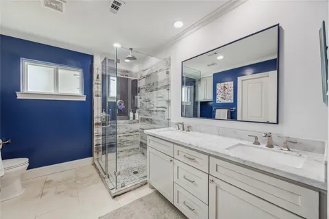 a spacious bathroom with a granite countertop sink mirror and double