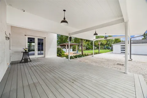 a view of a porch with wooden floor and fence