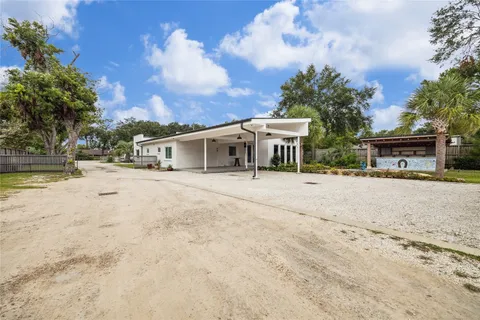 an aerial view of residential house with outdoor space and parking