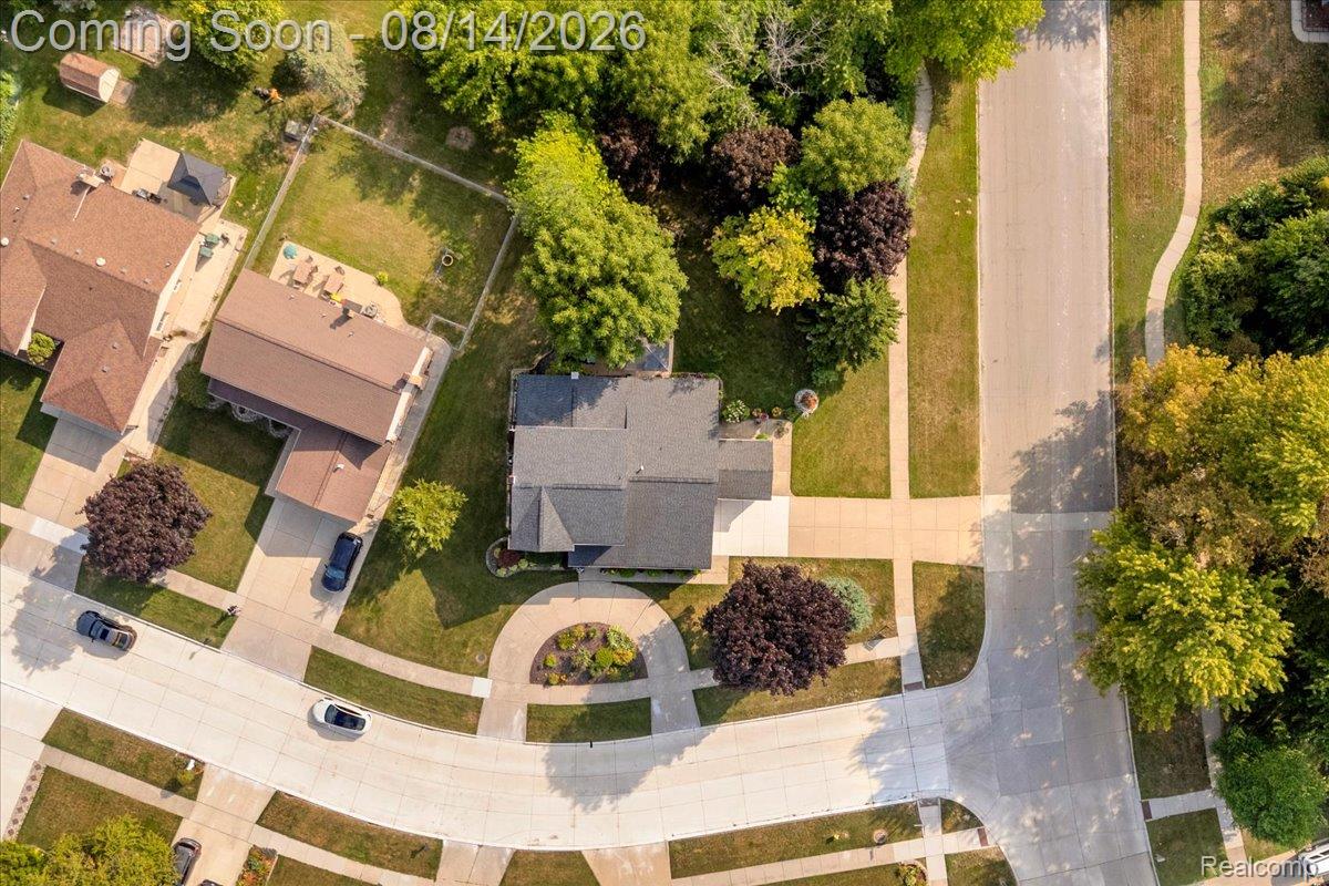 47321 Susan Road Macomb, MI 48044 - Photo 41 of 46 Paved driveway leading to a residence with a gabled roof