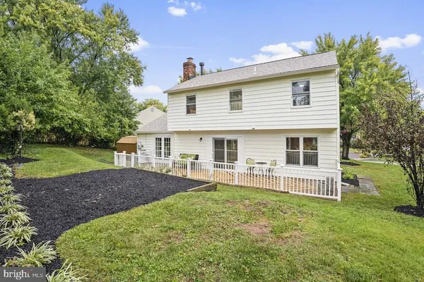 a view of a house with a yard and deck