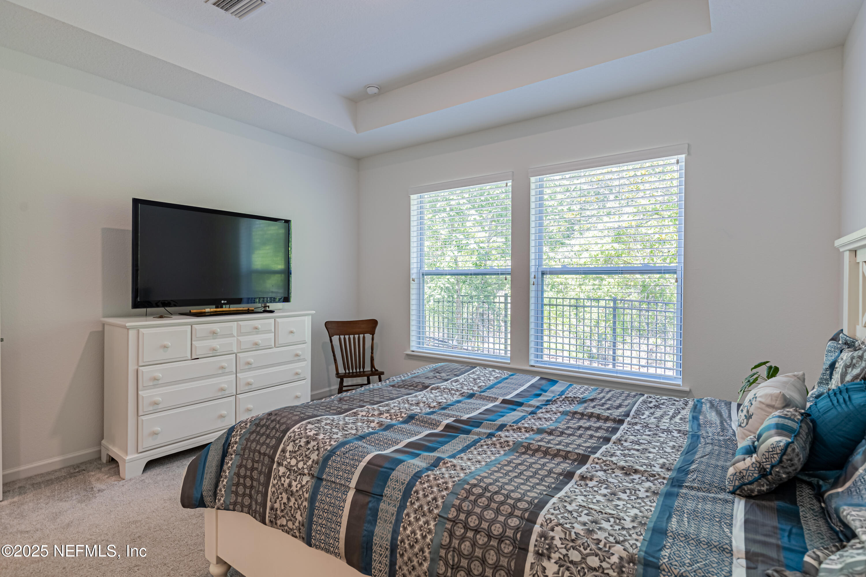 383 Windswept Way Street St. Augustine, FL 32092 - Photo 24 of 34 a bedroom with a bed and a flat screen tv
