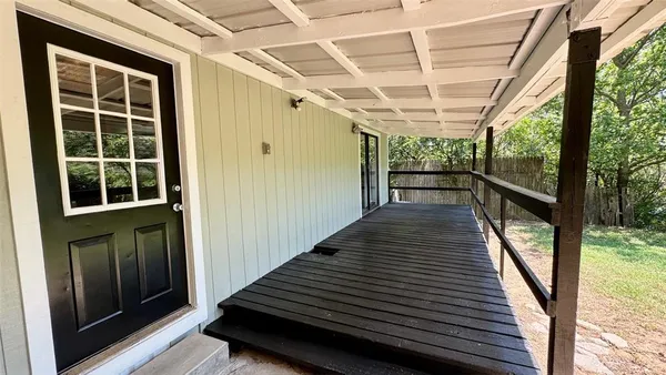 a view of porch with wooden floor