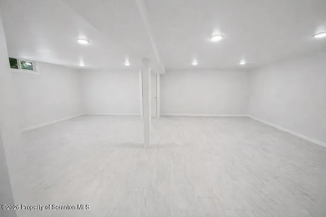 an empty room with a empty space and windows