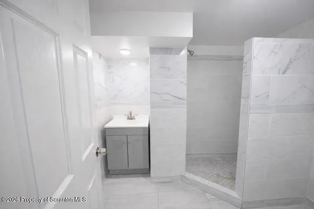 a bathroom with a shower and sink