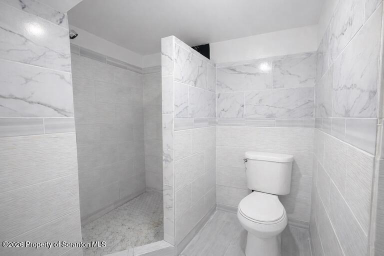 1125 Watson Street Scranton, PA 18504 - Photo 14 of 20 a bathroom with a toilet and a shower
