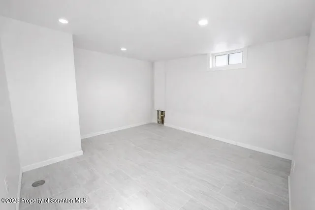 an empty room with a empty space and windows