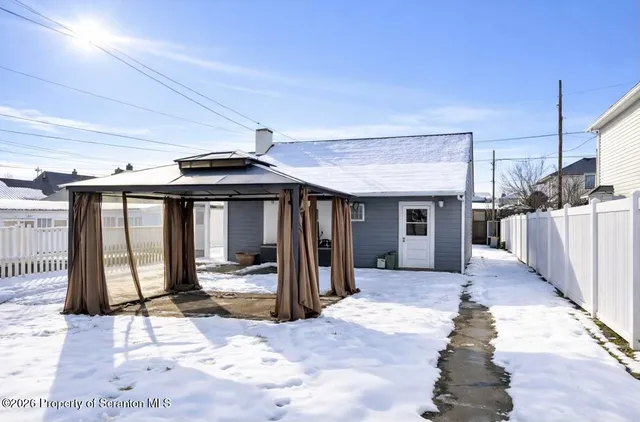 a view of a porch with wooden floor and a fireplace