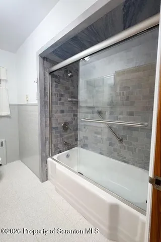 a bathroom with a bathtub and a shower