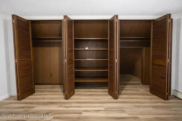 a view of walk in closet with empty racks