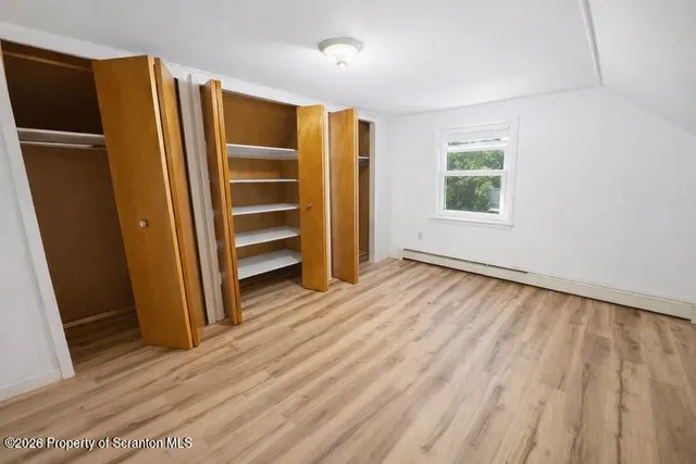 a view of an empty room with a closet