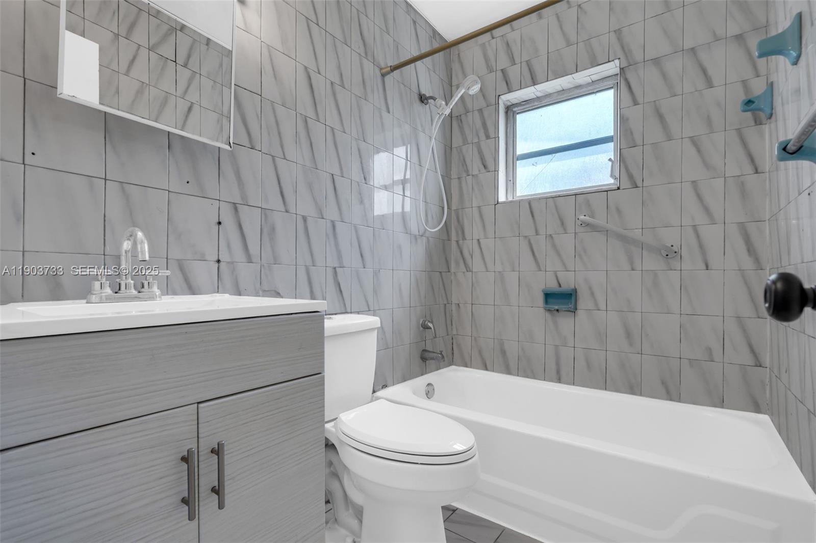 2809 Southwest 23rd Terrace, Unit 2807 Miami, FL 33145 - Photo 11 of 13 a bathroom with a sink a toilet and bathtub