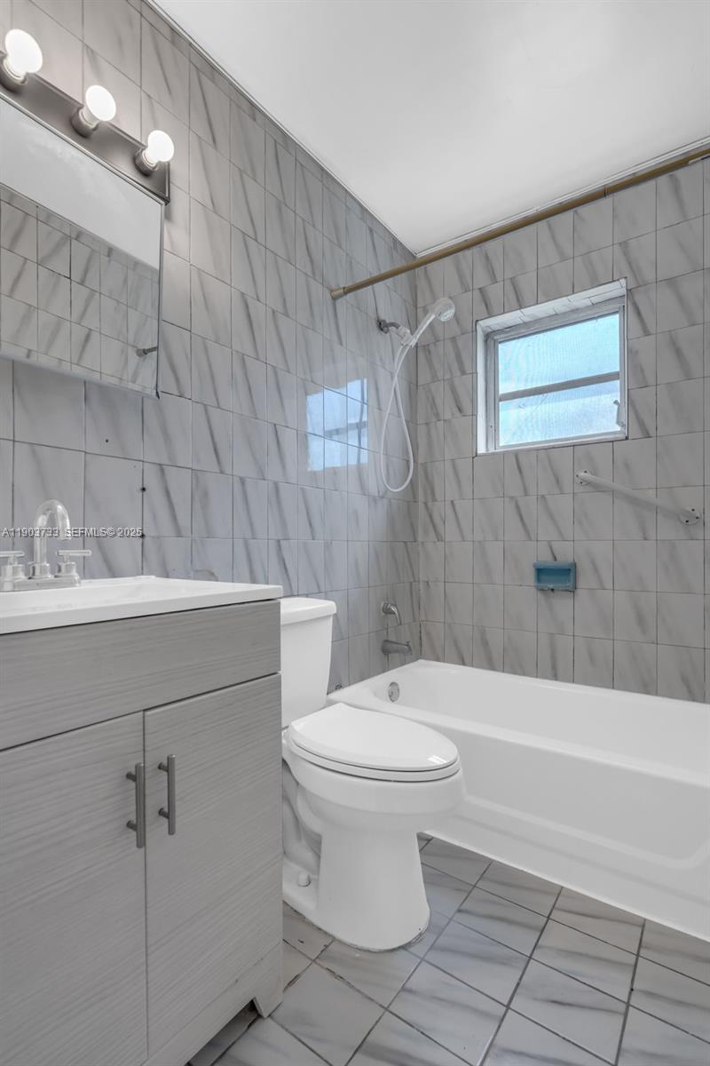 2809 Southwest 23rd Terrace, Unit 2807 Miami, FL 33145 - Photo 12 of 13 a bathroom with a toilet a sink and bathtub