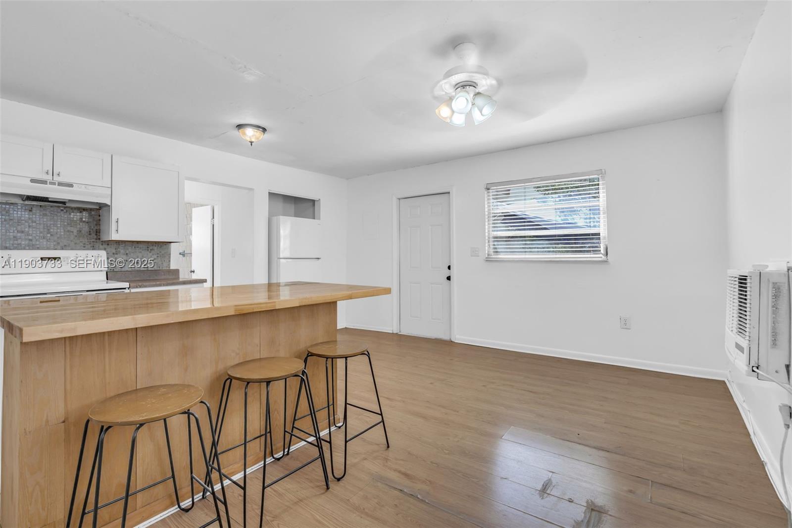 2809 Southwest 23rd Terrace, Unit 2807 Miami, FL 33145 - Photo 3 of 13 a kitchen with stainless steel appliances granite countertop a stove top oven a sink dishwasher and cabinets with wooden floor