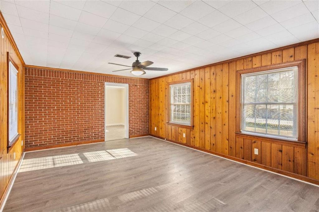 614 Burnett Ferry Road Southwest Rome, GA 30165 - Photo 15 of 29 an empty room with wooden floor and windows
