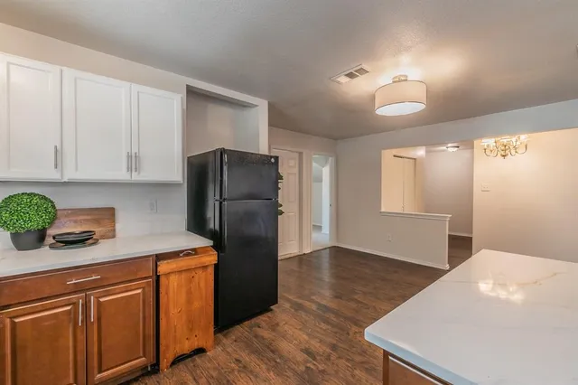a kitchen with stainless steel appliances a refrigerator sink and cabinets