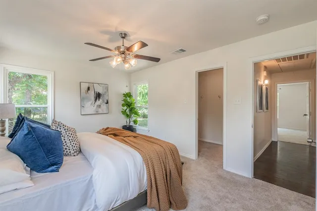 a bedroom with a large bed and a chandelier