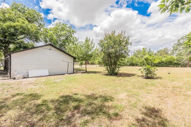 a view of a house with a yard and garage