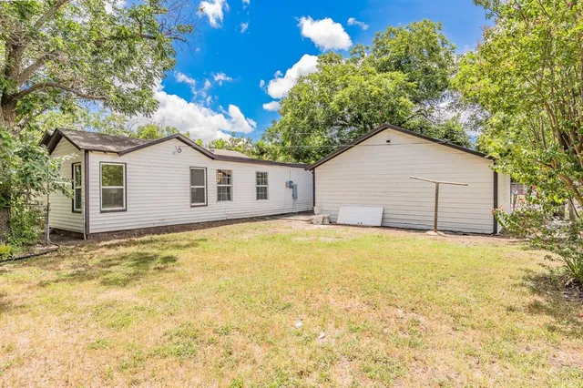 an aerial view of a house with outdoor space and street view