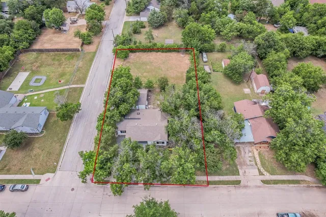 an aerial view of a house with a yard and garden