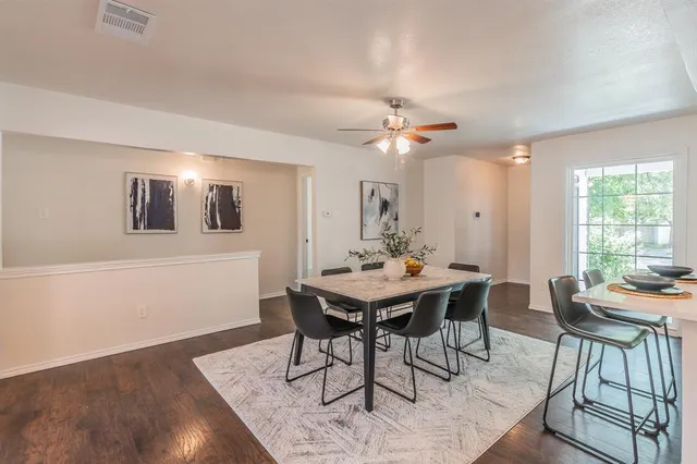 a view of a dining room with furniture and window