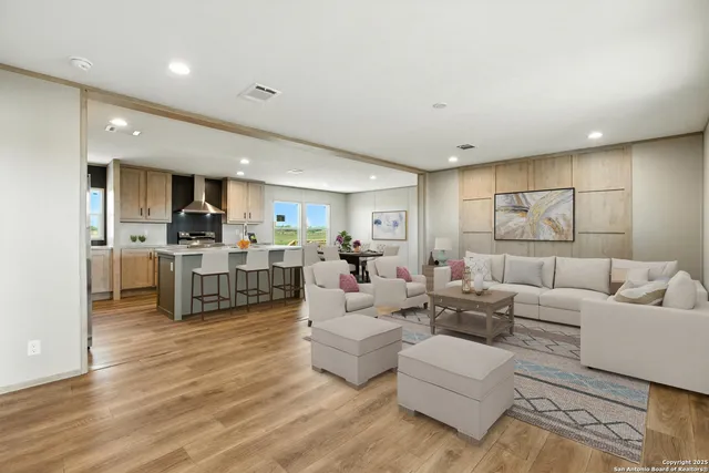 a kitchen with kitchen island granite countertop a sink window and cabinets