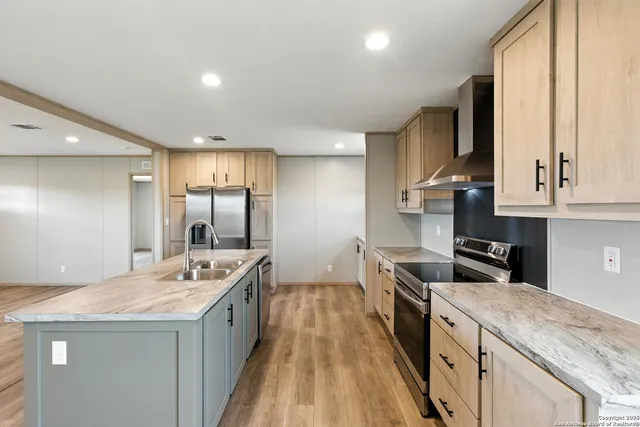 a kitchen with granite countertop white cabinets and stainless steel appliances